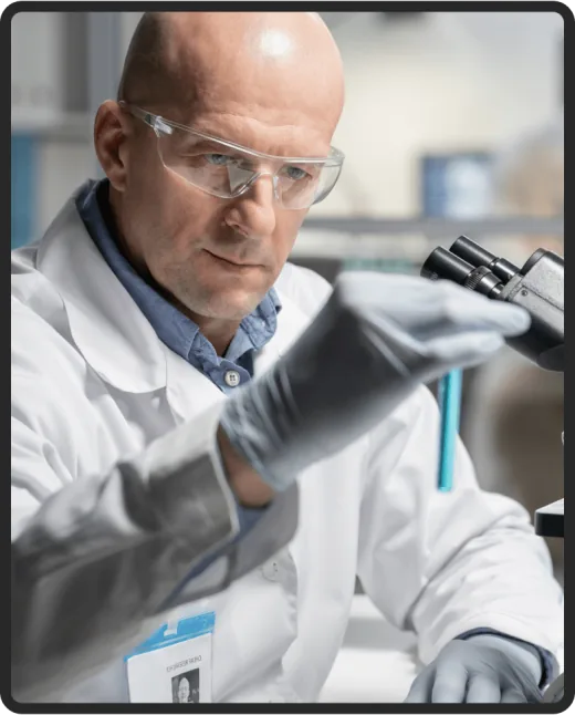 Researcher examining a sample under a microscope